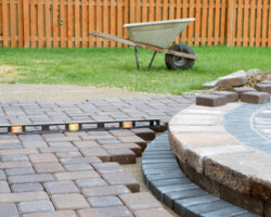 Wehn building a patio prepare to use level and barrel constantly, patio island have polymeric sand layed and job completion almost done when final pavers cut and placed